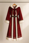 Red velvet coat with white fur trim on a hanger against a neutral background